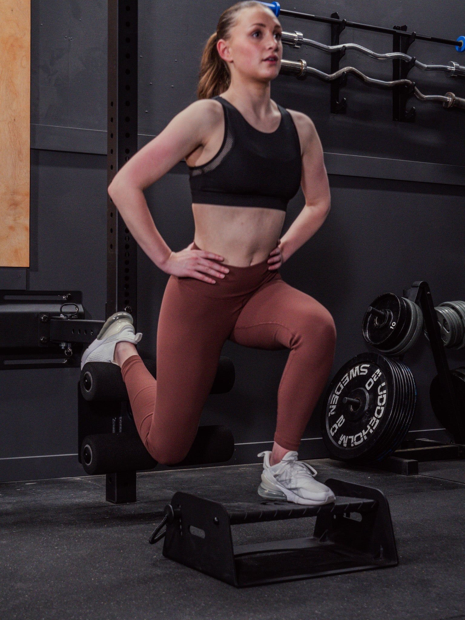 Woman performing bulgarian split squats with Exponent Edge's Flex Wedge