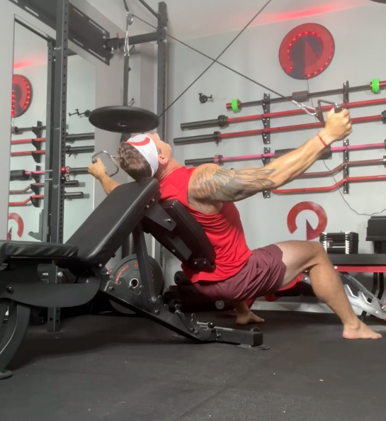 man performing a weight lifting exercise on the Infinity Bench