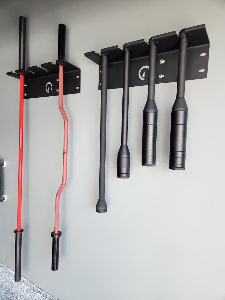 Exponent Edge Mace and Club Holder mounted to a wall holding clubs and barbells