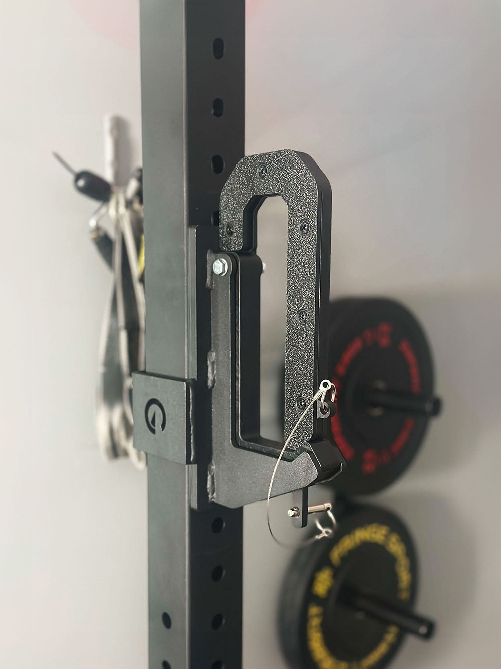 The Calf Cup rack attachment is the best calf solution for those looking to train calves at home but also use the device as a standard J-Cup. This image presents The Calf Cup connected to a workout rack.