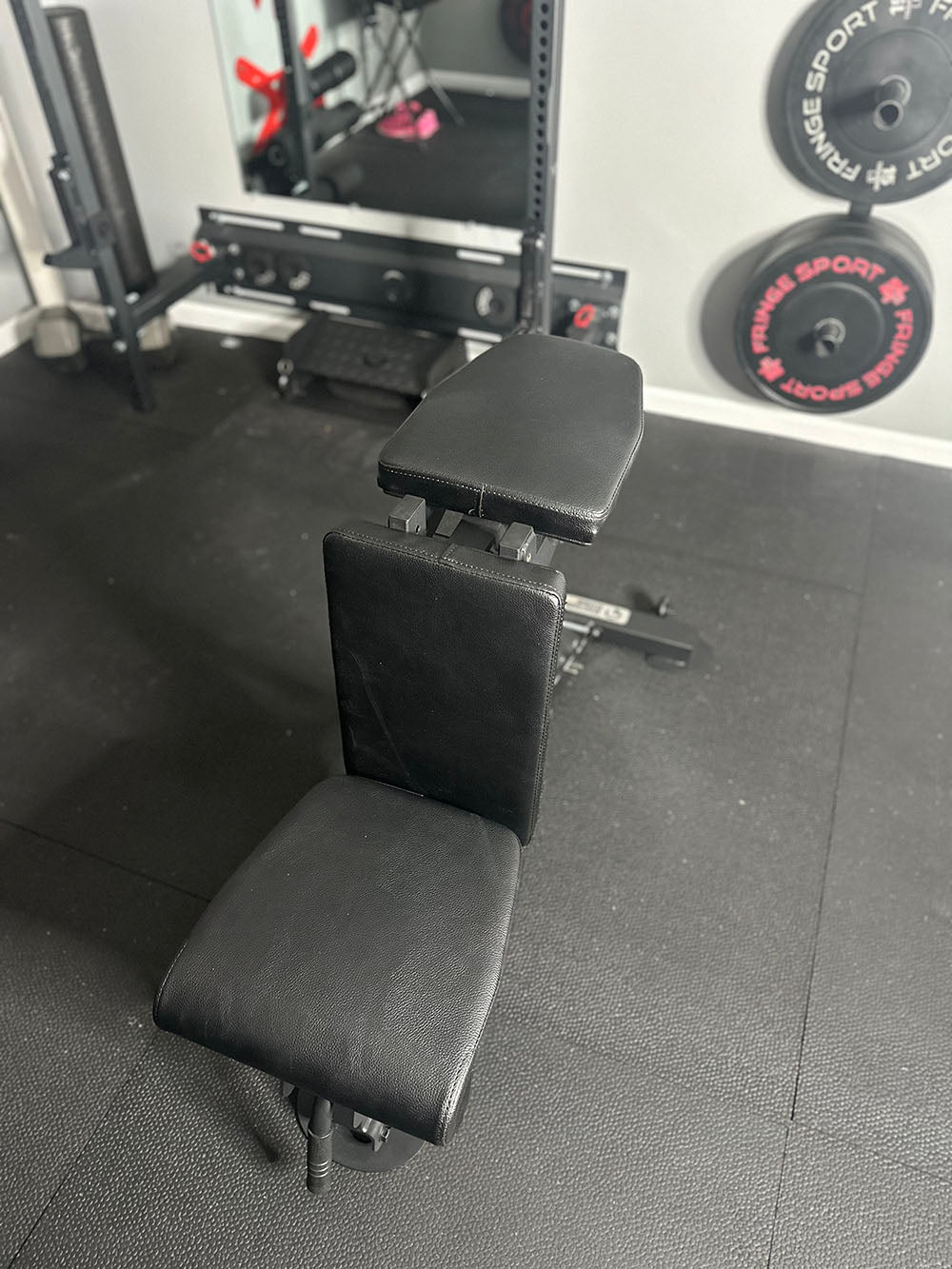 The Edge Infinity Bench is a bench that combines three separate benches all into one bench. You get the benefits of a flat bench, incline bench, and half bench all in one device. This image presents the bench from an elevated front view.