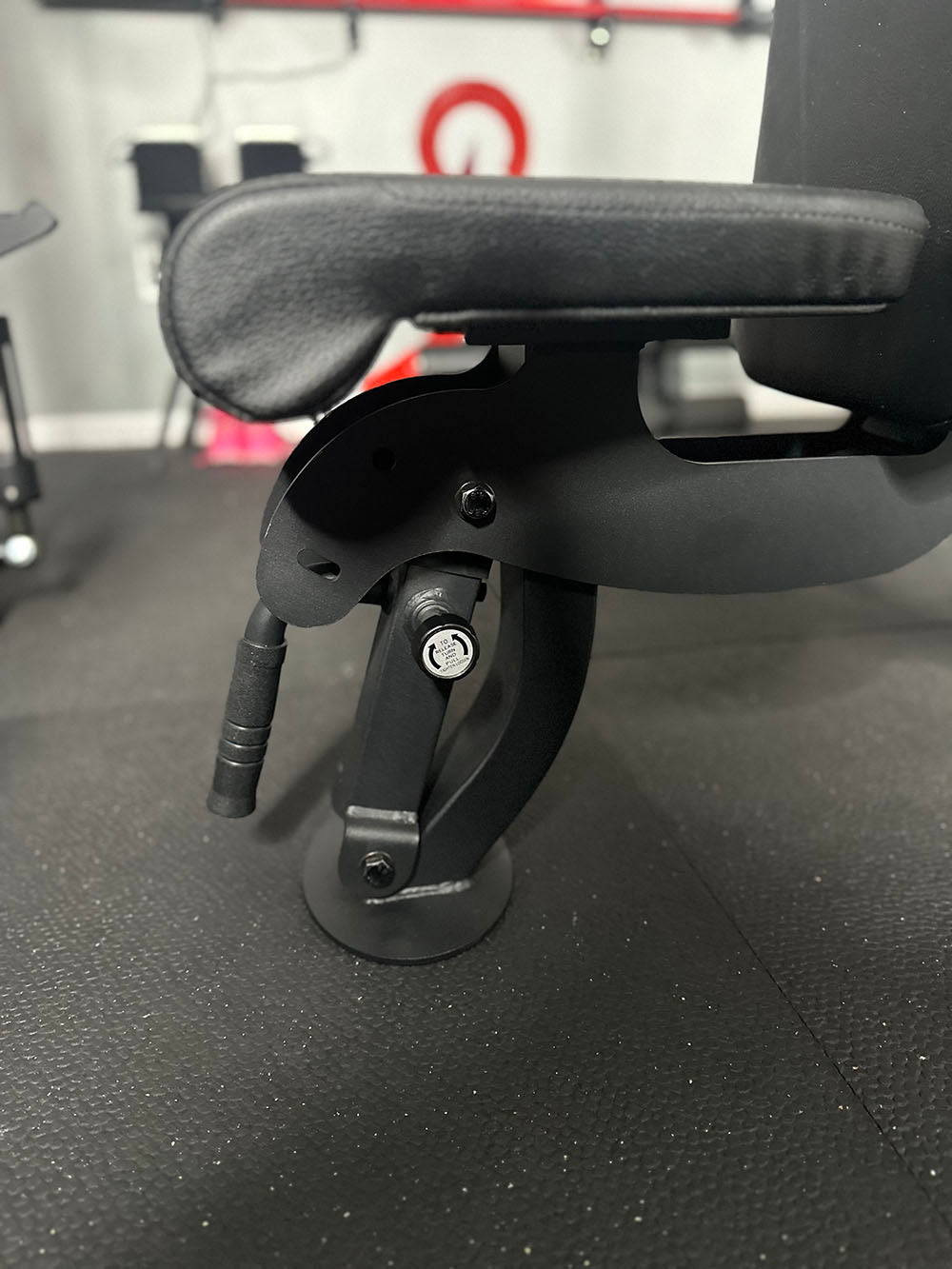 The Edge Infinity Bench is a bench that combines three separate benches all into one bench. You get the benefits of a flat bench, incline bench, and half bench all in one device. This image presents a close up of the seat section of the bench.