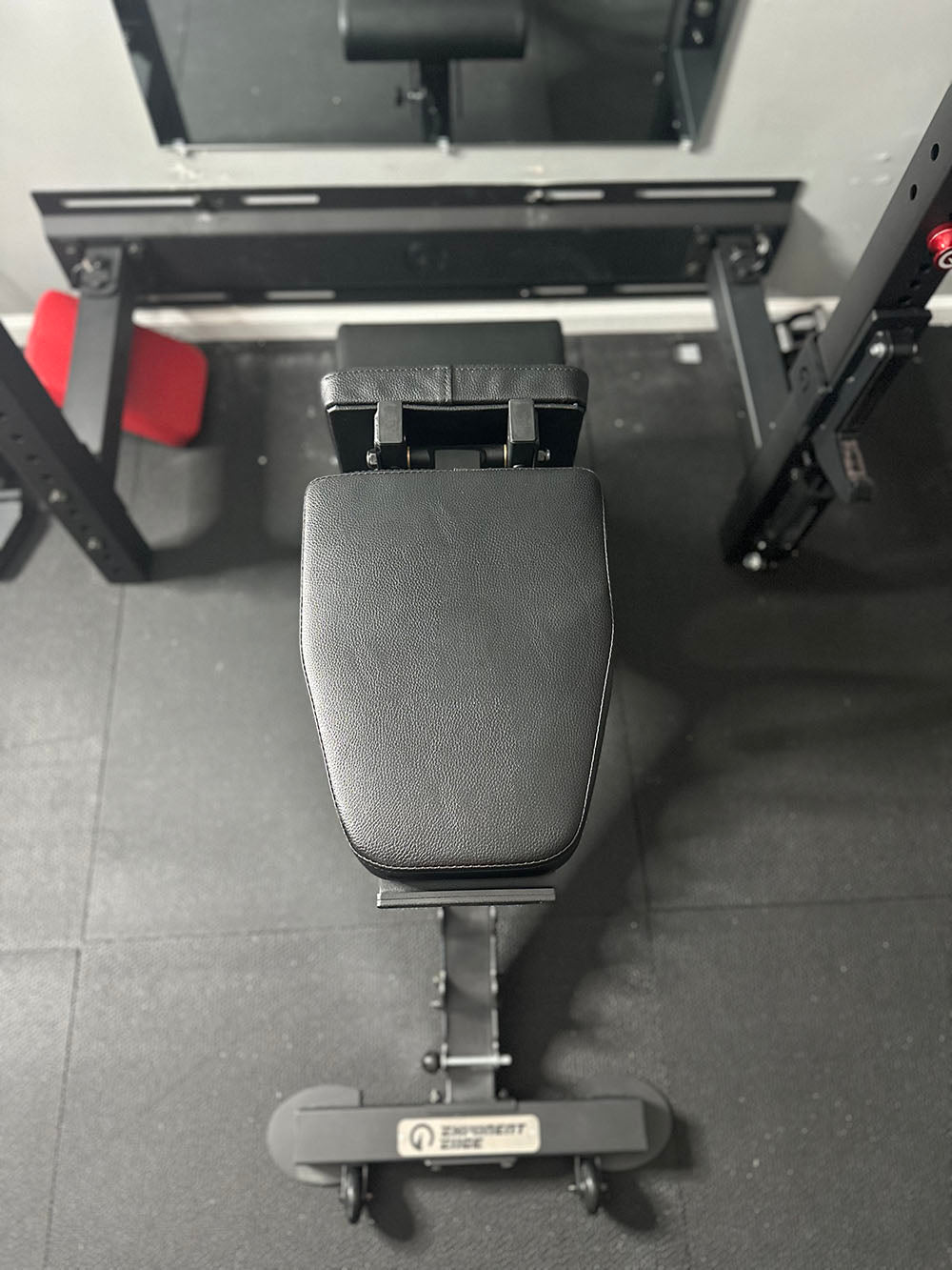 The Edge Infinity Bench is a bench that combines three separate benches all into one bench. You get the benefits of a flat bench, incline bench, and half bench all in one device. This image presents the bench from a top view.