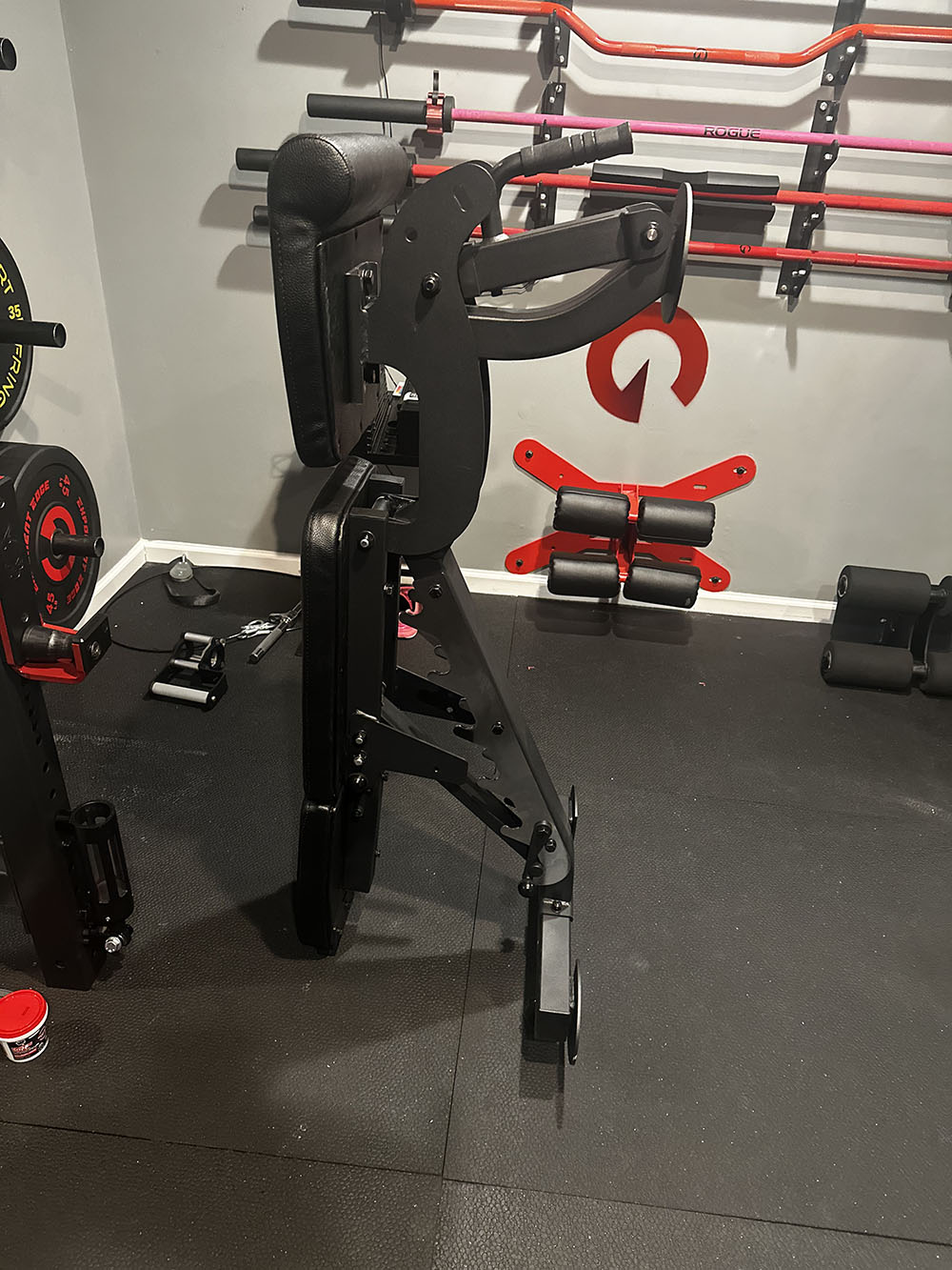 The Edge Infinity Bench is a bench that combines three separate benches all into one bench. You get the benefits of a flat bench, incline bench, and half bench all in one device. As shown in this image, the bench can be stored vertically to maximize space. 