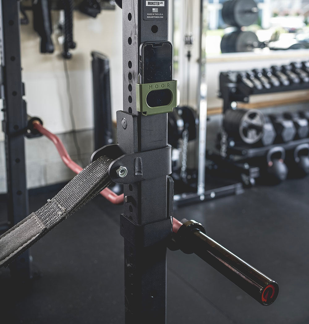 The Edge Bar is a mix between a shortened cambered bar and an EZ Bar. Perfect for enhanced bicep workouts, chest workouts, and more. This image presents the Edge Rackable Cambered Bar on a workout rack.