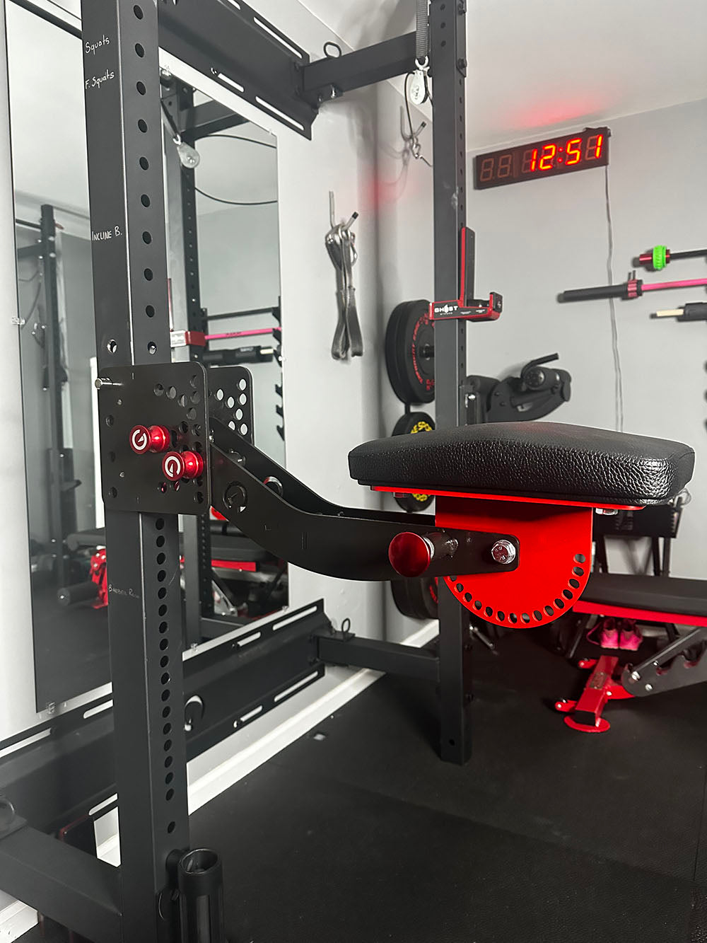 The rack-attaching, Infinity Arm can be utilized for chest-supported, arm-supported, back-supported, head-supported, and many other supported exercises. This image presents the Infinity Arm attached to a rack in a home gym.