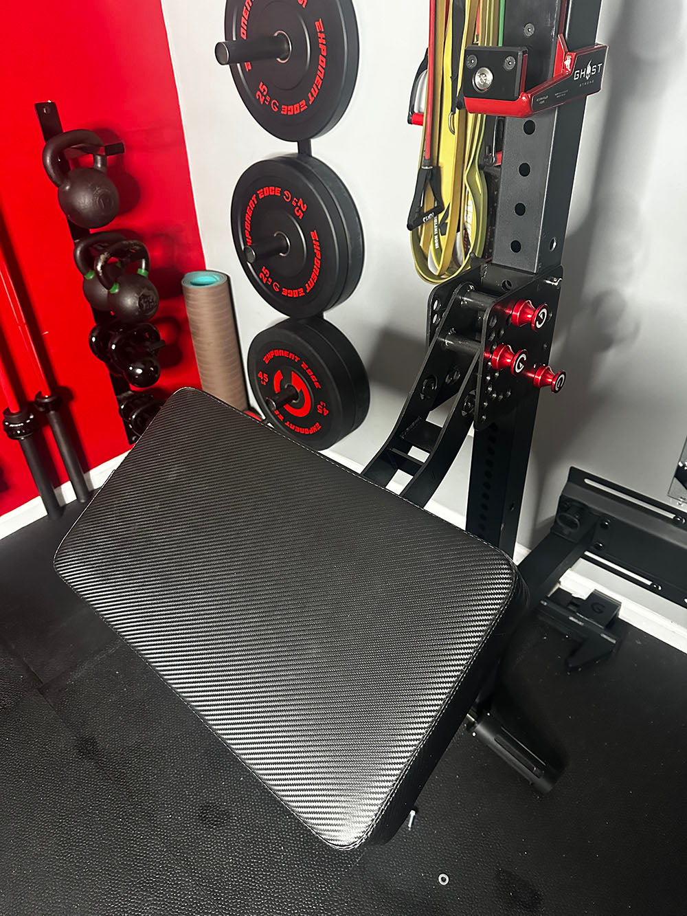 The rack-attaching, Infinity Arm can be utilized for chest-supported, arm-supported, back-supported, head-supported, and many other supported exercises. This image presents the Infinity Large Pad Attachment attached to a power rack from a front view.
