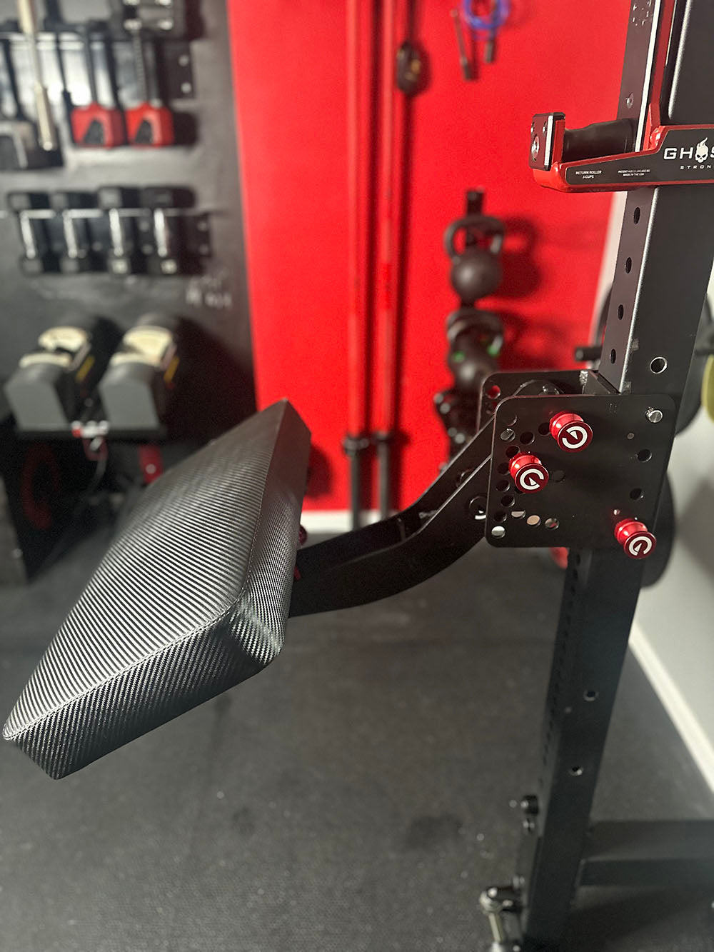 The rack-attaching, Infinity Arm can be utilized for chest-supported, arm-supported, back-supported, head-supported, and many other supported exercises. This image presents the Infinity Large Pad Attachment attached to a power rack from a side view.