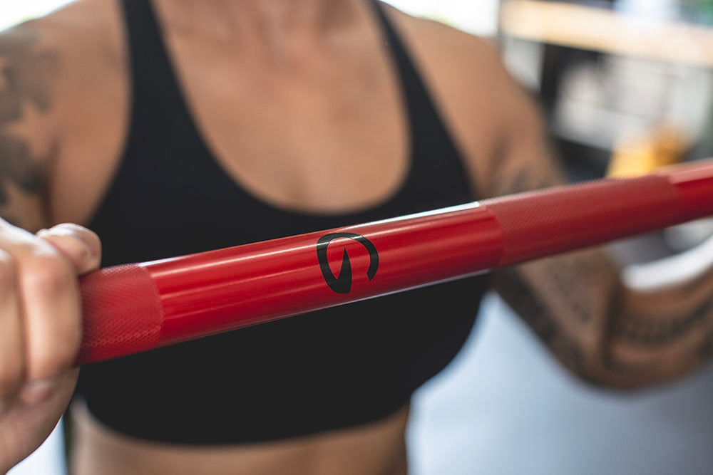 The Infinity Bar is a hybrid Bodybuilding and Powerlifting barbell. This images presents a close-up view of the Infinity Bar being used for a workout.